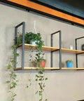 Heavy Duty Wall Shelf Brackets Black Metal Floating Supports Square Tube Wall Mounts Built Tight For Heavy Lifting With Mounting Screws Included Space Saving Rack Hardware No Wooden Plank Needed Three Pack Set holding potted plants on a wall.