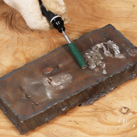 120 Grit Zirconia Sanding Bands For Detail Work Set on metal surface with rotary tool in use