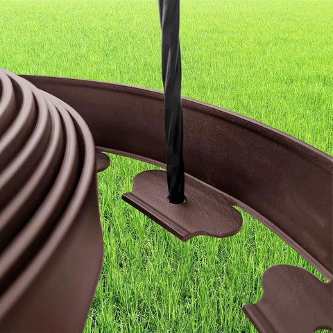 Close-up of Brown 20 Feet Landscape Edging Kit No Digging With 18 Spikes Durable PE installed in grass field.