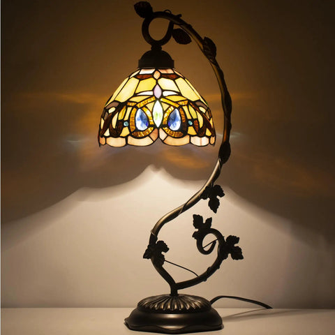 Tiffany Style Stained Glass Table Lamp With Bronze Metal Leaf Base, 21 Inch Tall, 8 Inch Shade, lit in a dim room
