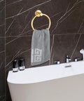 Slick Wall Mounted Towel Ring Crafted From Premium Stainless Steel tailored for top shelf bathrooms and kitchens with a gray towel.