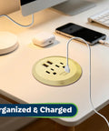 GaN Desk Grommet With 60W USB-C PD Fast Charging, 2 USB-A Ports, And Duplex Outlet Receptacles, Gold Finish on desk