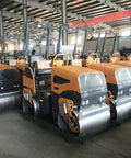 Heavy Duty 800kg Hydraulic Double Drum Vibratory Road Roller Crushes Pavement Repair Jobs With Rock Solid Asphalt Surface Leveling Gear built tough, lined up in warehouse.