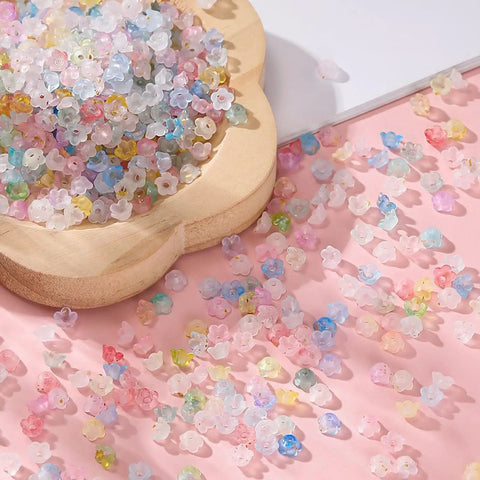 Acrylic Frosted Flower Beads Six Millimeter With Golden Speckles Matte Mini Floral Spacer Beads Bulk 1000pcs scattered on a surface