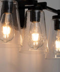 Close-up of Vintage Industrial 3 Light Vanity Sconce In Black With Bubble Glass Shades, highlighting filament bulbs.