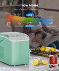 Hella Fast Portable Ice Maker With Built In Handle Makes Twenty Six Pounds Fresh Ice Daily on countertop with lemons and cocktails.