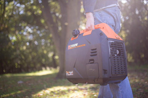 Person carrying Ultra Quiet 2350 Watt Portable Inverter Generator With Fuel Shutoff Gas Powered Lightweight 39 Pound Unit in park