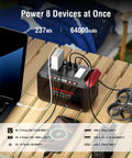 Portable 237Wh Solar Generator With Foldable 60W Panel charging multiple devices on a wooden table for camping and outdoor use.