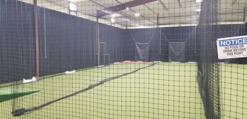 Indoor view of Batting Cage Net Only 12 Foot High HDPE 24 Twine 42 Ply With Door and Free 4 By 6 Vinyl Backstop With Target for practice