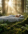 Person sleeping on Grounding Fitted Sheets With 25 Percent Silver Infused Fiber And Cotton in a forest setting