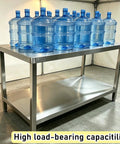 Solid As A Rock Stainless Steel Workbench With Dual Tier Shelves Heavy Duty Prep Table supporting multiple water jugs on top.