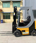 Battle Ready Counterbalance Industrial Forklift Truck 2.5 Ton with adjustable fork width, parked outside a warehouse.