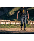 Person walking outdoors wearing Beefy 1.5 Inch Nylon Tactical Belt With Stainless Steel Buckle Converts To Tie Down Or Harness Heavy Duty