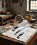 Three Piece Grommet Hole Punch Set With Steel Hollow Punches for leatherworking on a craftsman workbench in a rustic workshop