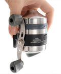 Close-up of Spincast Bowfishing Reel For Slingshot Bow Fishing Stainless Steel Construction held in hand showing handle and gear ratio.