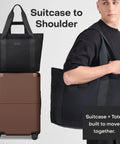 Front view of July Carry On Max expandable 21.5-inch dark brown carry-on luggage with black travel tote.