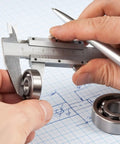 Person measuring 693ZZ Double Shielded Deep Groove Ball Bearing with caliper, showcasing precision sizing for skateboards and bikes.