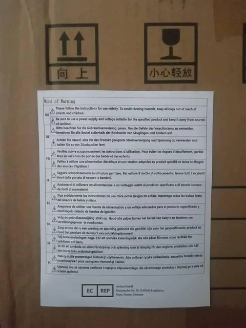 Cardboard box with multilingual safety instructions and symbols, including arrows and a fragile sign, emphasizing caution.