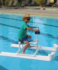 Child riding DIY float made with 12 Pack 5 Way PVC Fittings 1 Inch Schedule 40 Elbow Connectors, in a swimming pool