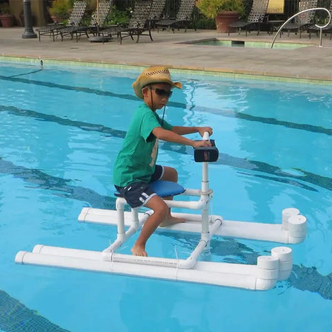 Child riding DIY float made with 12 Pack 5 Way PVC Fittings 1 Inch Schedule 40 Elbow Connectors, in a swimming pool