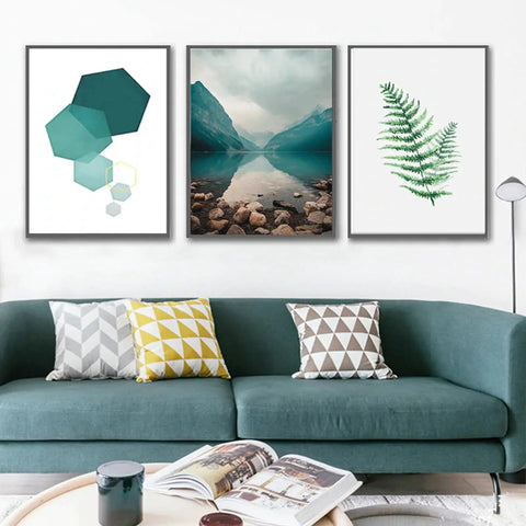 Modern living room with green sofa, geometric and nature-themed framed artwork on white wall