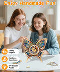 Two women assembling Butterfly Themed 3D Puzzle Clock Kit With Pendulum Wooden Model, showing blue purple wings and Roman numeral dial.