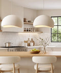 Bennyes Wabi Sabi Pendant Light 19.7 in White hanging above a kitchen island, showcasing cement texture and modern design.