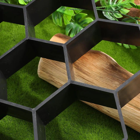 Close-up of hexagonal concrete molds for walkways and pavers with durable black plastic paver molds for outdoor pathways.