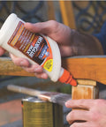 Person applying Elmer's Carpenter's Wood Glue Max 1 Gallon Tan Extra Strength on wooden furniture outdoors