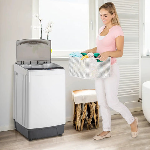 Woman carrying basket of colorful clothes to Slick 17.6 Lbs Compact Portable Washer With Clear Led Screen And Ten Program Settings For Swift Laundry Loads In Tight Dorms Or Apartments With Heavy Duty Drain Pump And Smooth Stainless Drum.