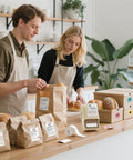 Smooth Sailing With This Sleek Portable Bluetooth Thermal Label Printer sporting inkless tech, showcased in a bakery setting with goods.