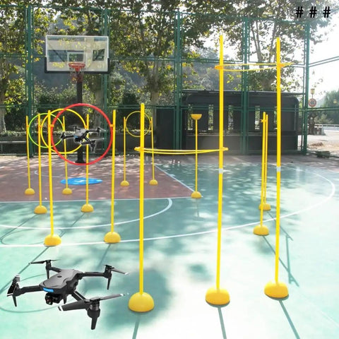 Drone Racing Obstacle Course Kit for Beginners and Pros set up on an outdoor basketball court with two drones flying through hoops.
