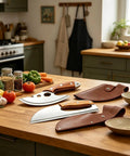 Heavy Duty Stainless Steel Meat Cleaver And 2 Piece Kitchen Chopper Set with leather covers on a wooden kitchen counter