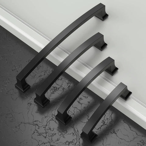 Four 10 Pack 7 Inch Matte Black Cabinet Handles With 177mm Hole Centers on sleek surface, showing side angle view
