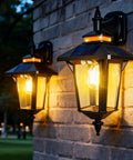 Outdoor Solar Wall Lights Dusk To Dawn With Motion Sensor, Four Solar Panels, Mounted on Brick, Illuminating a Path