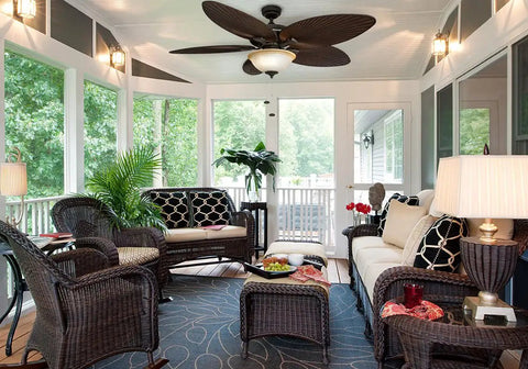 Palm Island 52 Inch Ceiling Fan With Light in a cozy sunroom, featuring wicker furniture and green plants, enhancing the tropical theme.