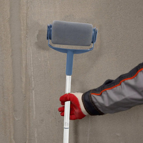 Heavy Duty Telescopic Paint Roller Kit With Extending Handle And Internal Reservoir For Walls Ceilings And Furniture held against a wall.