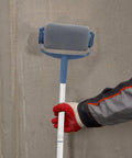 Extendable Paint Roller Kit With Telescopic Pole For Walls Doors And Ceilings, held by hand, gray lint free roller on wall.