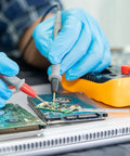 Technician using Heavy Duty Ceramic Soldering Iron Element Core White Replacement Heating Core for electronics repair.