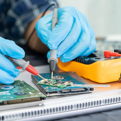 Technician using Heavy Duty Ceramic Soldering Iron Element Core White Replacement Heating Core for electronics repair.