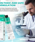 Front view of Molykote High Vacuum Grease 150 g tube and teal box, lab scene with a scientist.