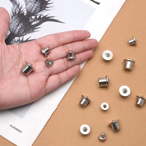 Rock Solid Stainless Steel Dowel Pins Center Point Set With 40 Pieces, showcasing various sizes in hand on paper background.