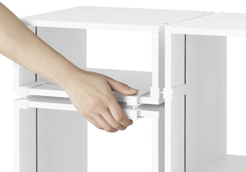 Hand assembling Clip And Cube 5-Piece Organizer System In White for flexible storage, showing interlocking cubes with ABS clips detail.