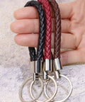 Premium Braided Pu Leather Key Fob With Solid Metal Hardware For Daily Grind Fly Woven Keychain Ring in black, red, and brown.