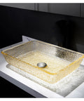 Go Big Or Go Home Bathroom Remodel With This Premium Crystal Glass Vessel Basin Featuring Tough Rectangular Design Heavy Duty Construction Smooth Pop Up Drain And Shatter Proof Build That Seriously Slaps - Yellow tinted rectangular glass basin on countertop with pop-up drain.