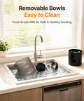Removable bowls of Top Shelf Dual Camera Automatic Pet Feeder With Two Separated Bowls And Six Liter Hopper being cleaned in sink.