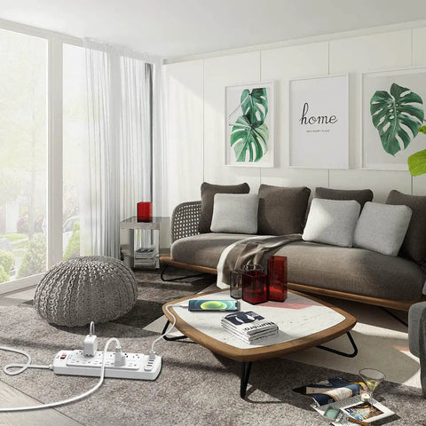 Living room with a 12 Outlet Power Strip With 4 USB Ports, 6 Ft Heavy Duty Extension Cord, 2700 Joules Surge Protector on coffee table.