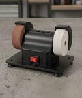 Top Shelf Twin Wheel Bench Grinder With Straightforward Rocker Switch Heavy Duty Electric Edger on workbench surface.