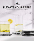 Slick Black Star Marble Coasters Set Of Six Natural Polished Stone Drink Guards For Coffee And Dining Tables Modern Minimalist Surface Protection shown with drinks.