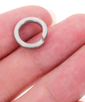 M8 304 Stainless Steel Split Ring Spring Lock Washer held between fingers, heavy-duty for screws and fasteners, pack of 100.